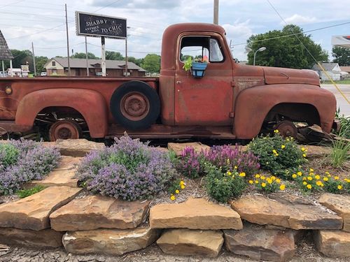 Vintage 1952 International Harvester L-110 pickup truck displayed outside Shabby To Chic antique store in Coffeyville, KS.